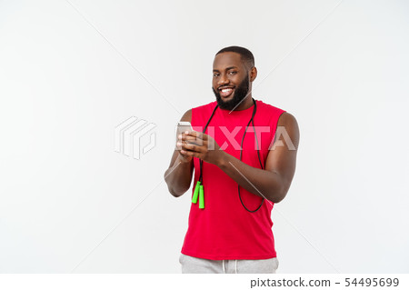 Mature fit African American man texting on mobile and holding elastic rope. 54495699