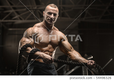 fitness athletes training using battle ropes fitness athletes training using battle ropes 54496326