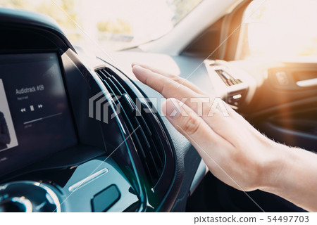 Hand checking the air conditioner in the car 54497703