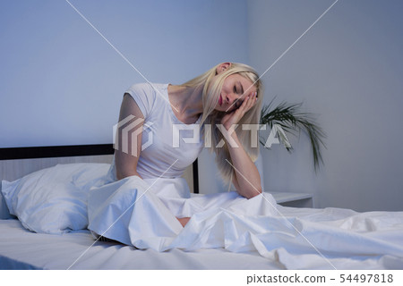Depressed woman awake in the night, she is 54497818