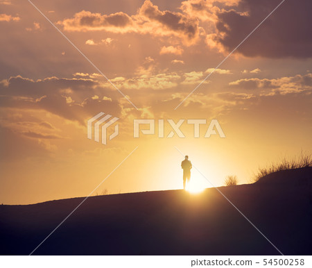 Traveller enjoys sunset at White Sands National 54500258
