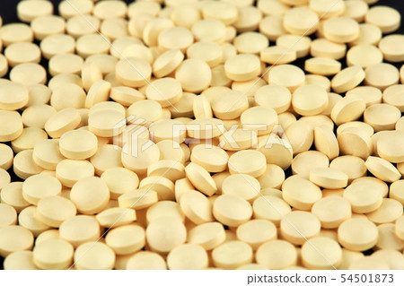 Close-up photo of many yellow pills. Medicine Close-up photo of many yellow pills. Medicine 54501873