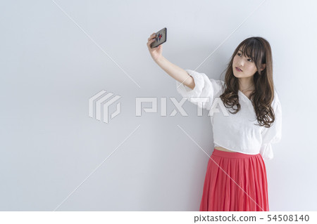 Woman using a smartphone Woman using a smartphone 54508140