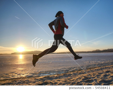 Couple runners running in winter nature. Frozen Couple runners running in winter nature. Frozen 54508411