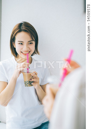 Young girls drinking tapioca milk tea Young girls drinking tapioca milk tea 54509578