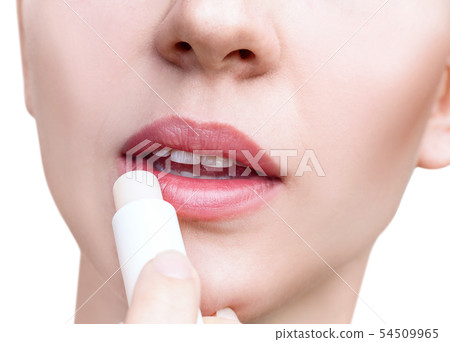 Young woman applying balsam on lips. Lips care concept. 54509965