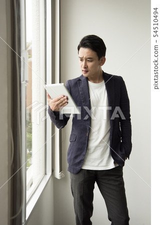 Men holding a tablet in the office Men holding a tablet in the office 54510494