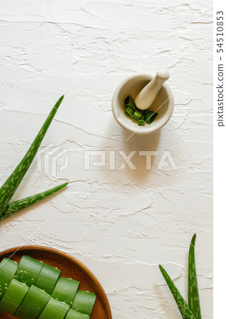 Top view of fresh aloe vera leaves in wooden bowl. 54510853