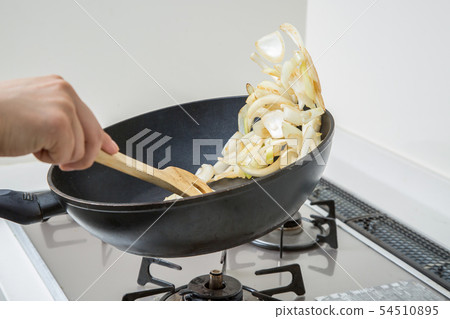 在平底鍋裡煎洋蔥在廚房的廚房裡 54510895