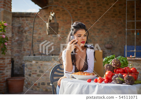 Sexy Italian eats spagetti on the garden terrace 54511071