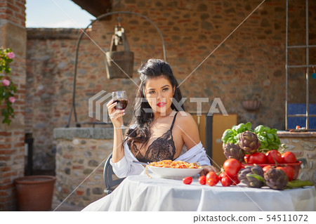 Sexy Italian eats spagetti on the garden terrace Sexy Italian eats spagetti on the garden terrace 54511072
