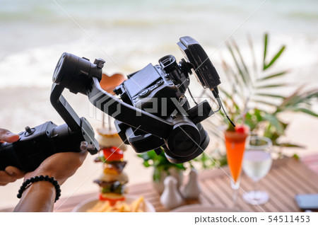 Professional working with mirrorless camera and Professional working with mirrorless camera and 54511453