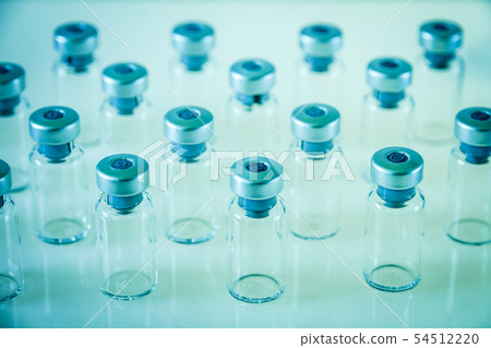 Vaccine glass bottles on blue background Vaccine glass bottles on blue background 54512220
