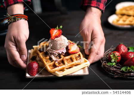 Chef serving freshly made waffle dessert Chef serving freshly made waffle dessert 54514406