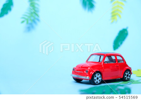 small toy red car driven by summer 54515569