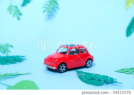 small toy red car driven by summer 54515570