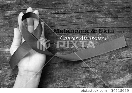 Melanoma and skin cancer black awareness ribbon 54518629