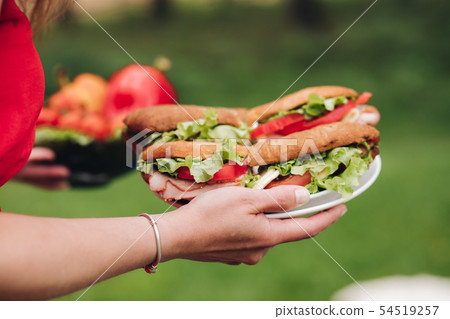 Woman bringing fresh sandwiches. Close-up of Woman bringing fresh sandwiches. Close-up of 54519257