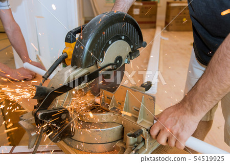 Sparks while grinding iron, metal sawing, worker 54519925