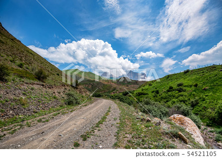 Picturesque landscape with narrow road in summer mountains 54521105