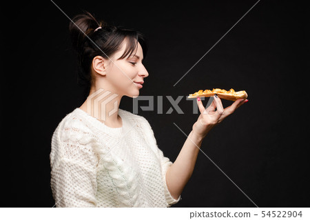 Young caucasian woman with tail eating piece of 54522904