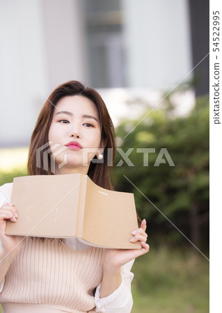 A woman holding a book 54522995