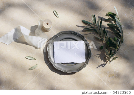 Summer wedding stationery mock-up scene. Blank cotton place card on vintage silver plate with olive Summer wedding stationery mock-up scene. Blank cotton place card on vintage silver plate with olive 54523560