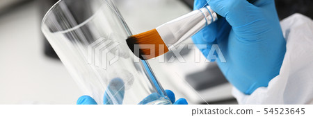 Male hand in blu protective gloves hold brush Male hand in blu protective gloves hold brush 54523645