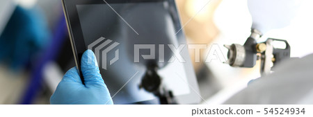 Painter hold in hands digital tablet pc selecting color Painter hold in hands digital tablet pc selecting color 54524934
