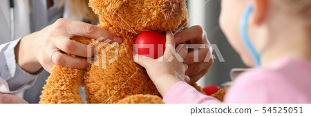 Little girl hold in arms toy red hear playing with teddy bear Little girl hold in arms toy red hear playing with teddy bear 54525051