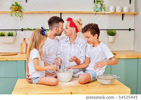 Happy family cooking in stylish kitchen together Happy family cooking in stylish kitchen together 54525445