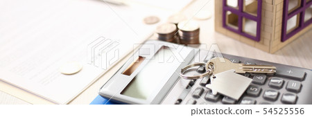 Calculator, House Model, Notebook, Key on Table Calculator, House Model, Notebook, Key on Table 54525556