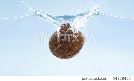 Ripe coconut falling in clear water with splash 54528463