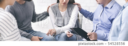 People counseling desperate woman at group therapy session People counseling desperate woman at group therapy session 54528556
