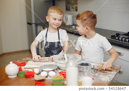 Little boy cook the dough for cookies Little boy cook the dough for cookies 54528647