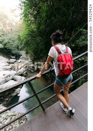 female tourist with backpack walking 54529424
