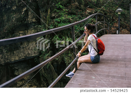 female tourist with backpack walking female tourist with backpack walking 54529425