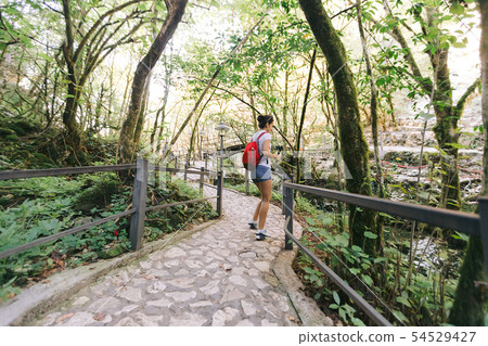female tourist with backpack walking female tourist with backpack walking 54529427