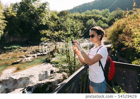female tourist with backpack walking female tourist with backpack walking 54529429
