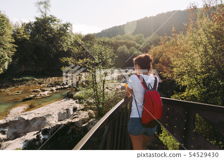 female tourist with backpack walking female tourist with backpack walking 54529430