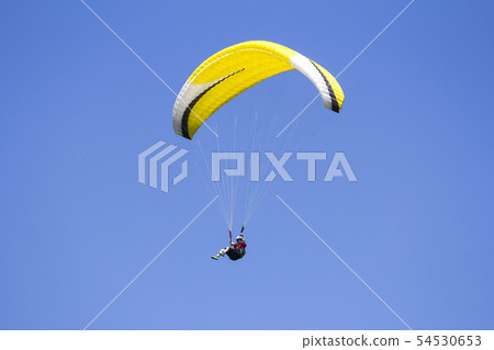Paragliding in the blue sky as background extreme Paragliding in the blue sky as background extreme 54530653