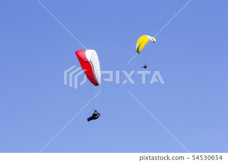 Paragliding in the blue sky as background extreme Paragliding in the blue sky as background extreme 54530654