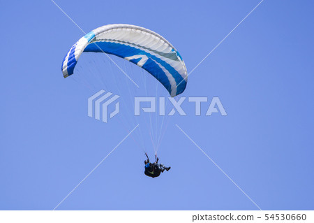 Paragliding in the blue sky as background extreme Paragliding in the blue sky as background extreme 54530660