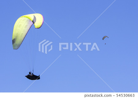 Paragliding in the blue sky as background extreme Paragliding in the blue sky as background extreme 54530663