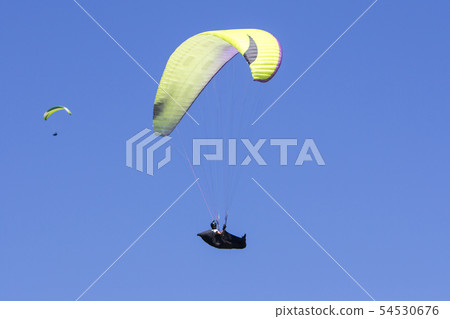 Paragliding in the blue sky as background extreme Paragliding in the blue sky as background extreme 54530676