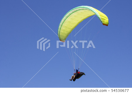 Paragliding in the blue sky as background extreme Paragliding in the blue sky as background extreme 54530677