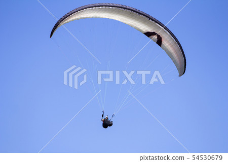 Paragliding in the blue sky as background extreme Paragliding in the blue sky as background extreme 54530679