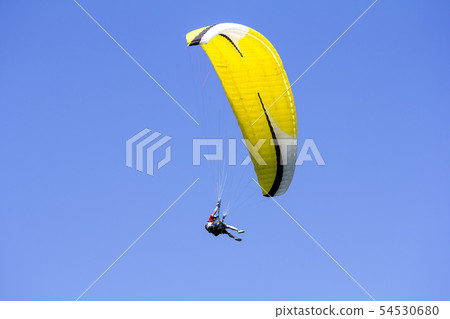Paragliding in the blue sky as background extreme Paragliding in the blue sky as background extreme 54530680