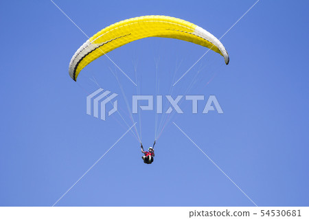 Paragliding in the blue sky as background extreme Paragliding in the blue sky as background extreme 54530681