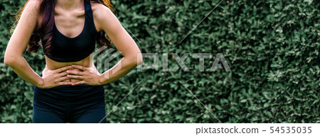 Young sport woman having pain at her stomach. 54535035